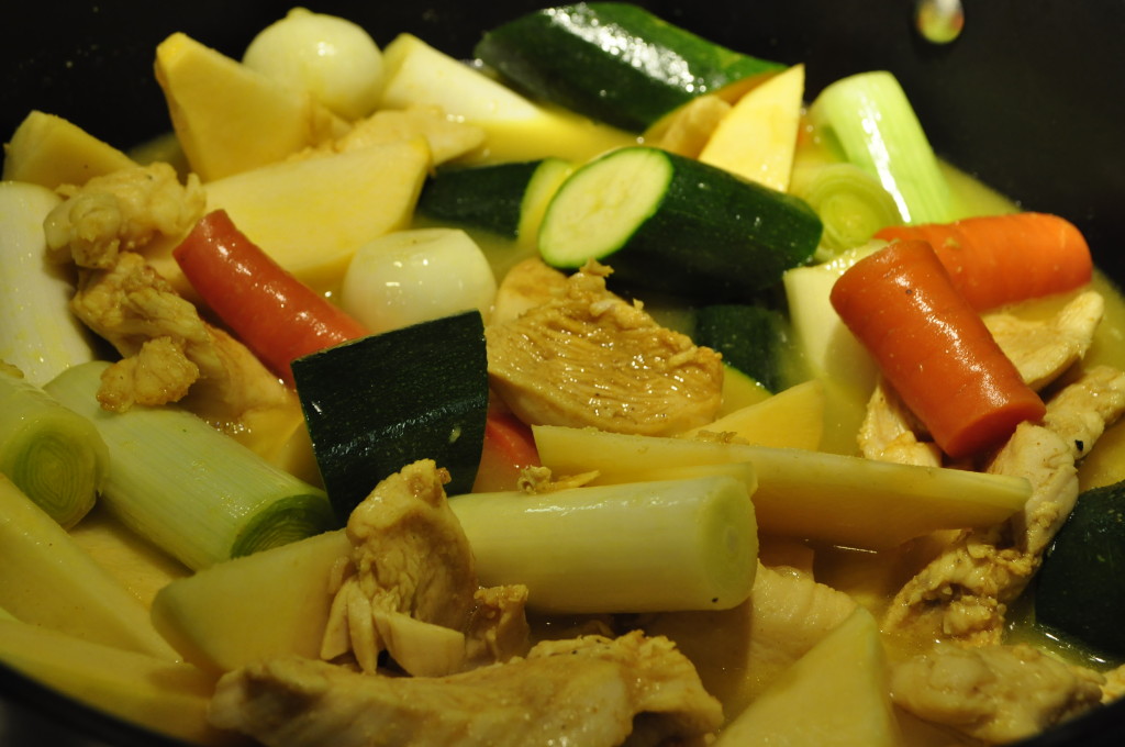 Chicken and vegetables in buttery, spice-filled broth